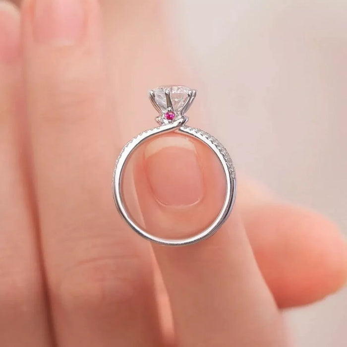 Sterling silver moissanite ring with 1 carat center stone, elegant jewelry piece showcasing sparkling gemstone and sleek band design.