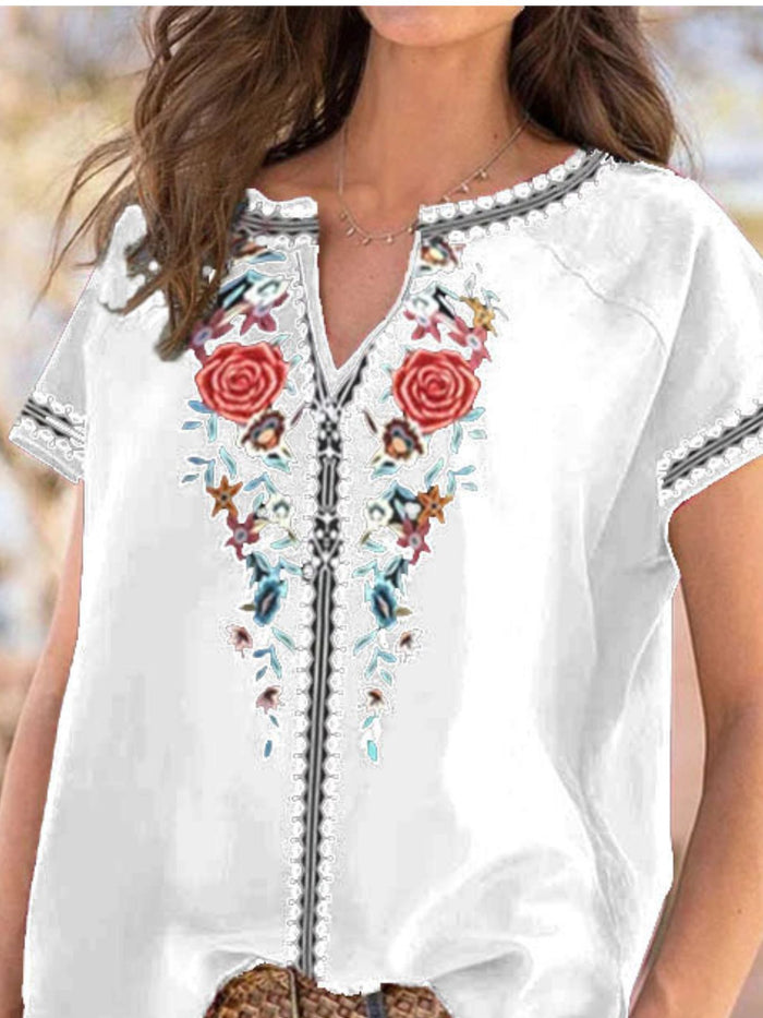 Floral notched short sleeve blouse from Trendsi, featuring a stylish design with vibrant floral patterns and a notched neckline.