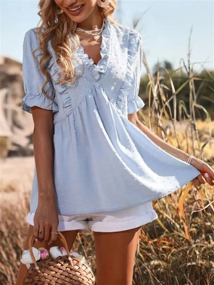 Ruffled V-Neck Blouse in soft fabric, featuring a feminine design and flowy sleeves by Trendsi.