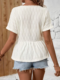 V-neck blouse by Trendsi featuring decorative buttons and long sleeves, made of lightweight fabric in a stylish design.