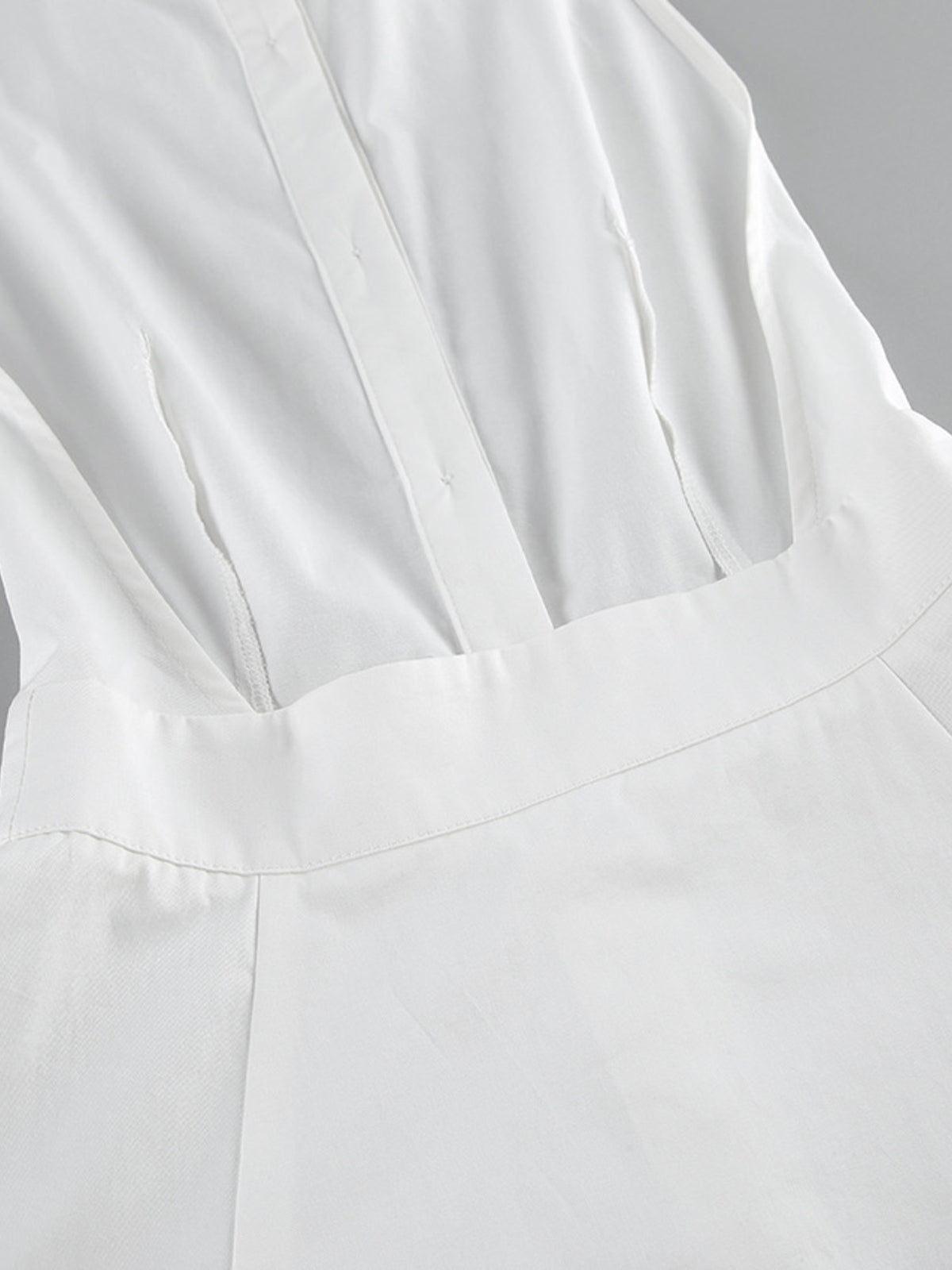 Backless button-front maxi dress by Trendsi featuring a flowing silhouette and elegant design, perfect for summer or special occasions.