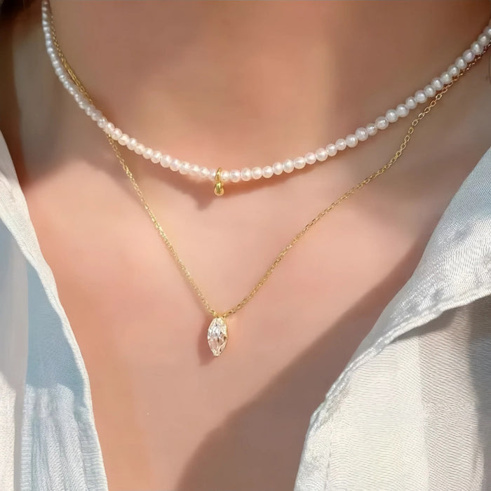 Sterling silver Céleste Zircon pendant necklace with delicate chain, featuring a sparkling zircon gemstone in a dainty design.