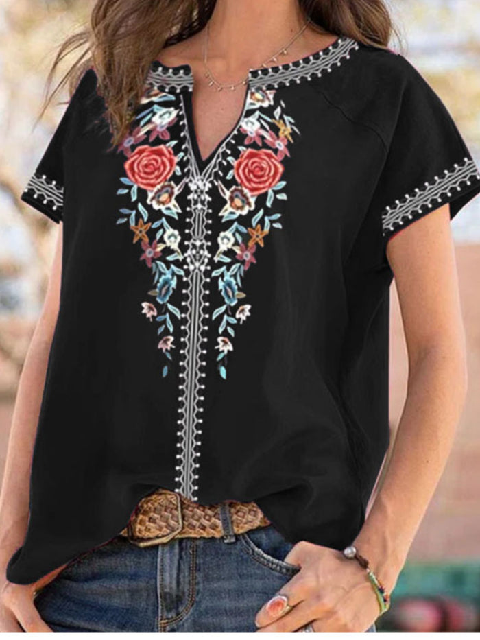 Floral notched short sleeve blouse from Trendsi featuring a relaxed fit and vibrant floral pattern, perfect for casual wear.