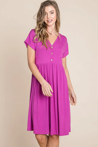 V-neck button front dress from Trendsi, featuring a stylish design with a fitted waist and knee-length hem.