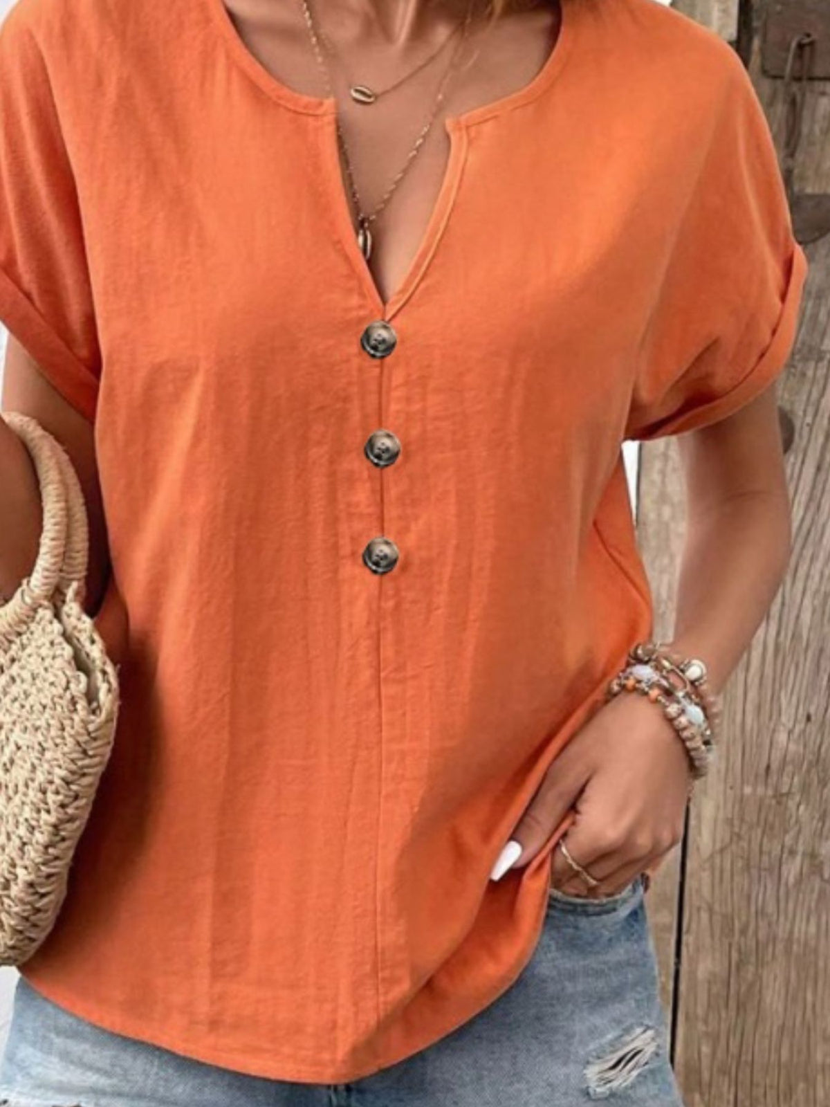 Trendsi notched short sleeve blouse in a soft fabric, featuring a relaxed fit and stylish neckline detail.