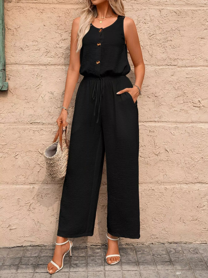 Sleeveless button-front wide-leg jumpsuit by Trendsi, shown in a stylish, lightweight fabric with a relaxed fit and modern design.