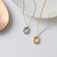 Sterling silver geometric pendant necklace with 18K gold plating by Trendsi, featuring a modern, minimalist design.
