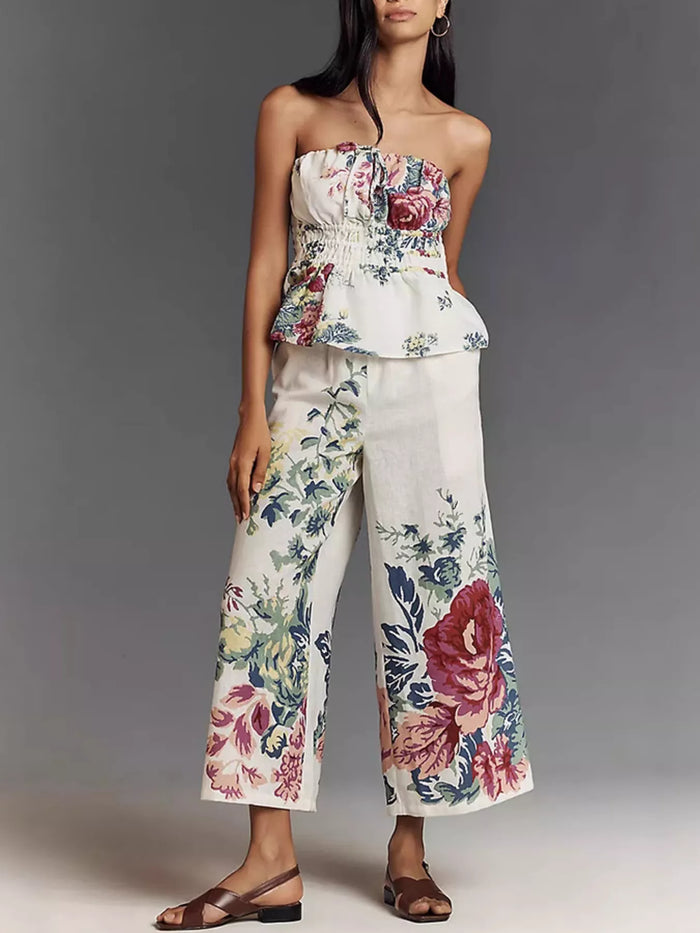 Floral print strapless top and wide-leg pants set by Trendsi, featuring a stylish two-piece outfit with vibrant flower patterns.