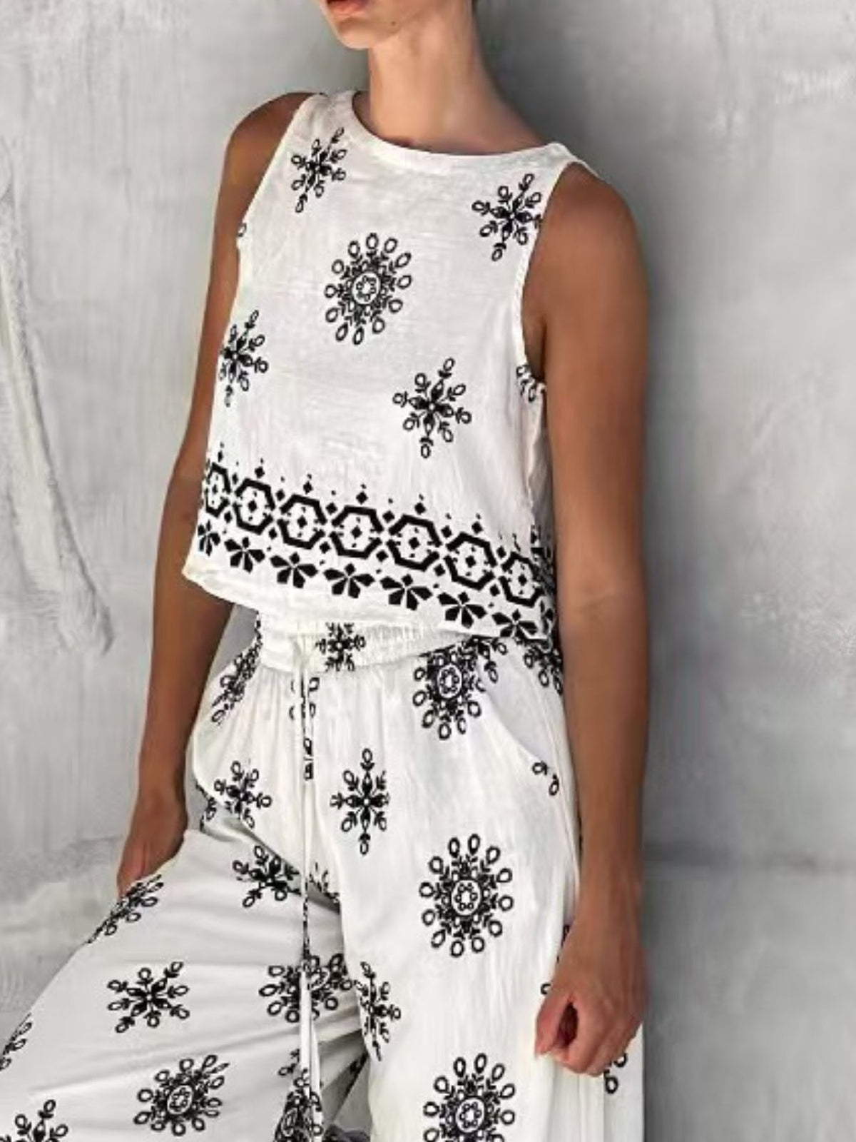 Trendsi sleeveless top and wide-leg pants two-piece set, stylish casual outfit with sleeveless top and flowy wide-leg pants.