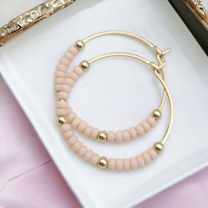 Bijou by SAM gold hoop earrings with pale pink accents, boho style, showing the elegant hoops on a white background.