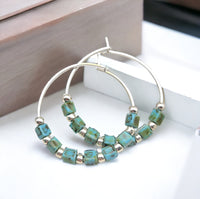 Silver and turquoise boho hoop earrings by Bijou by SAM featuring intricate detailing and vibrant color accents.