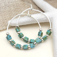 Silver and turquoise hoop earrings featuring boho-style design from Bijou by SAM, showcasing intricate details and vibrant colors.