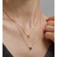 Mini initial necklace by Sahira Jewelry Design featuring a delicate pendant with a personalized initial on a fine chain.