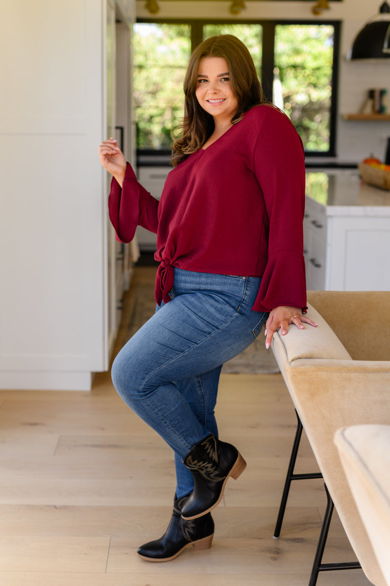 Flare And A Bow Top close-up of trumpet sleeves and tied hem"