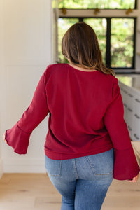  Flare And A Bow Top front detail of textured woven blouse with bow tie