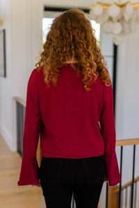 A Flare And A Bow Top styled look with trumpet sleeves and tie hem detail"