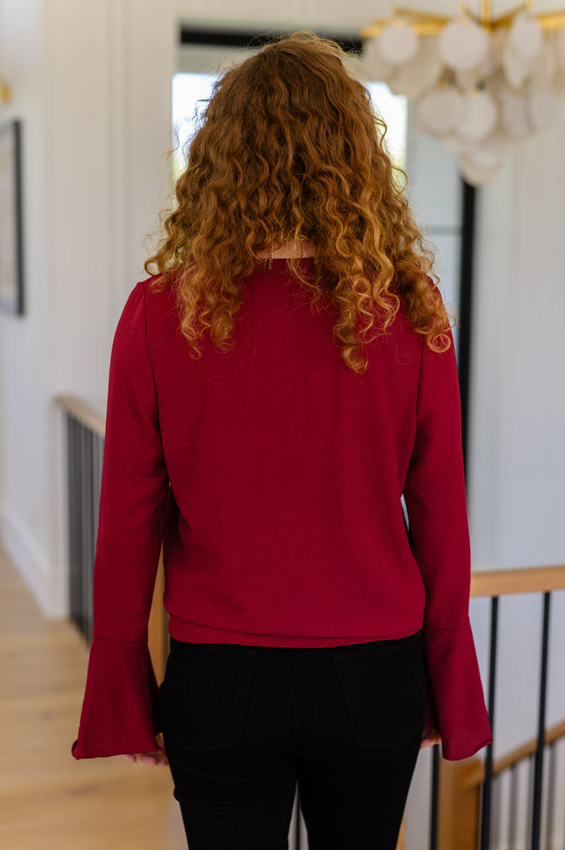 A Flare And A Bow Top styled look with trumpet sleeves and tie hem detail"